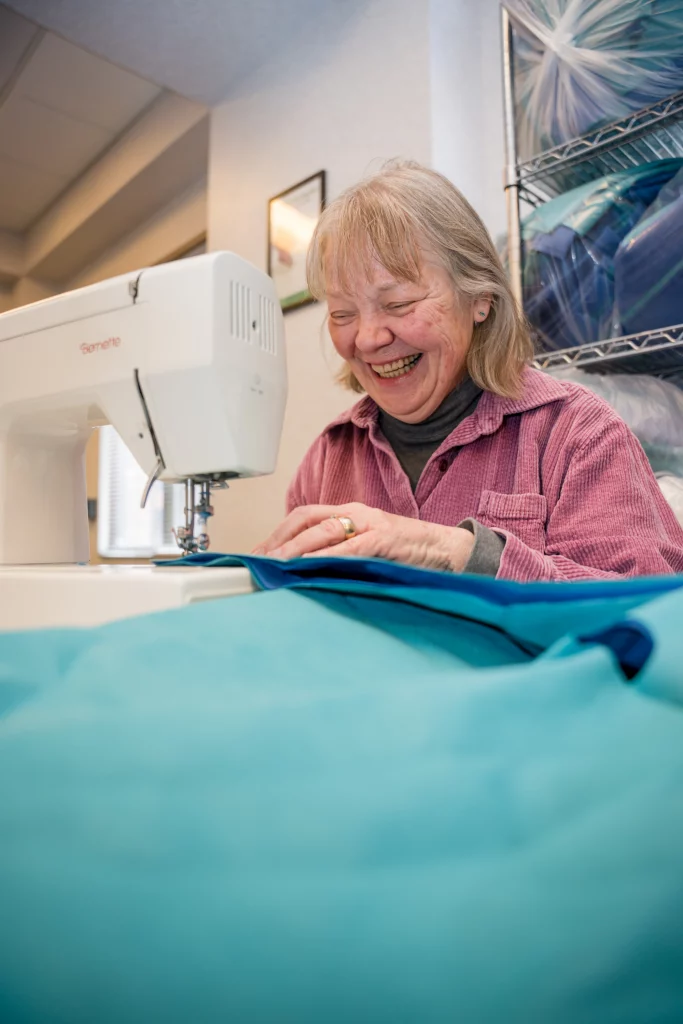 Diana Oliver, left, and Kythryn Drios are local seamstresses who work with Northern Arizona Healthcare to sew blue wrap into usable products, as seen in this May 4, 2022 photo. Photo by Sean Openshaw, NAH Communications.