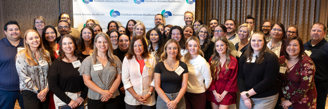 A group of Northern Arizona Healthcare staff and supporters pose together at an event, celebrating donor contributions that helped raise over $2.7 million for the nonprofit health care system